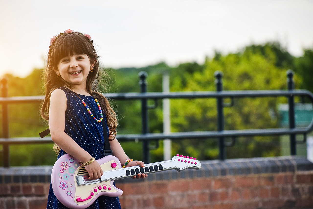 happy-joyous-contented-young-musician-learning-guitar